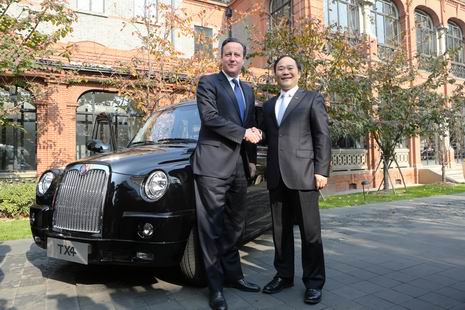 英国首相卡梅伦与金年会控股集团董事长李书福在伦敦经典黑色出租车前亲切握手。 